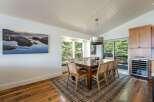This dining room boasts a large wooden table with six chairs, perfect for family gatherings.