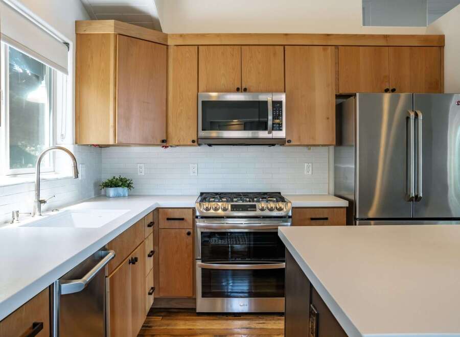 Experience modern living in this stunning kitchen, featuring sleek stainless steel appliances including a double oven range and a French door refrigerator.