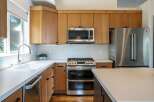 Experience modern living in this stunning kitchen, featuring sleek stainless steel appliances including a double oven range and a French door refrigerator.