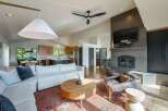 Experience modern living in this spacious open-concept home, featuring a stunning vaulted ceiling with a contemporary fan and a large pendant light.