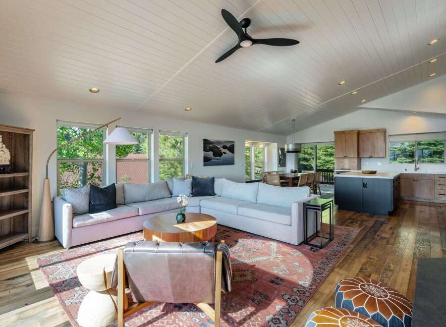 Experience modern living in this spacious open-concept home, featuring a large sectional sofa perfect for gatherings and a stylish kitchen island.