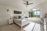 Experience breathtaking mountain views from this serene bedroom, featuring a comfortable king-size bed and ample natural light.