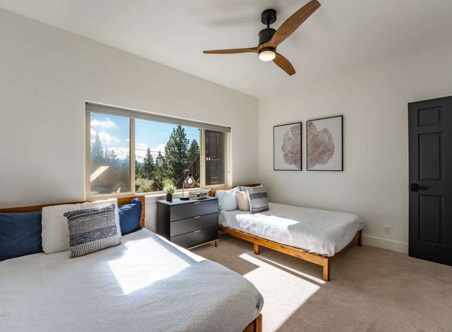 This bright bedroom features two twin beds, perfect for accommodating guests or family.