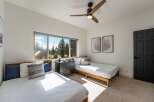 This bright bedroom features two twin beds, perfect for accommodating guests or family.