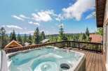 Relax and unwind in this luxurious hot tub, offering stunning panoramic views of the surrounding pine forest and distant mountains.