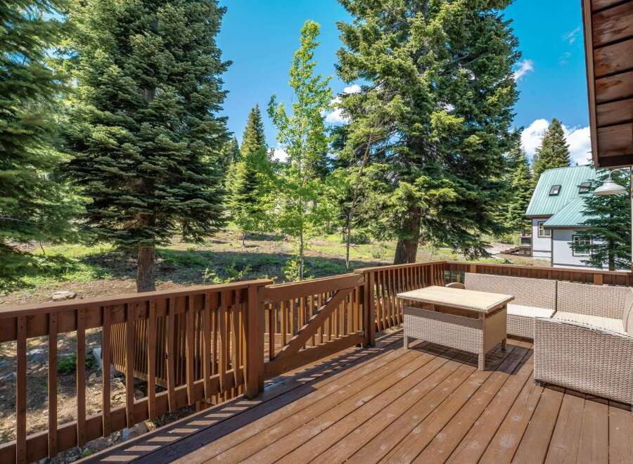 Enjoy the serene mountain views from this spacious wooden deck, perfect for outdoor entertaining or quiet relaxation.