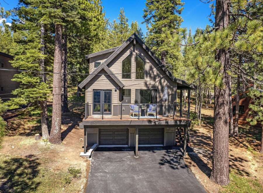 Nestled amidst tall pine trees, this modern mountain home offers a serene escape.