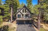 Nestled amidst tall pine trees, this modern mountain home offers a serene escape.
