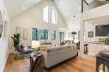 Experience modern living in this stunning open-concept home, featuring soaring vaulted ceilings and expansive windows that flood the space with natural light.