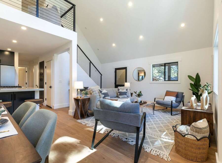Experience modern living in this stunning open-concept home, featuring a soaring vaulted ceiling and a chic loft overlooking the living area.