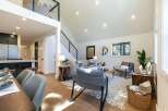 Experience modern living in this stunning open-concept home, featuring a soaring vaulted ceiling and a chic loft overlooking the living area.