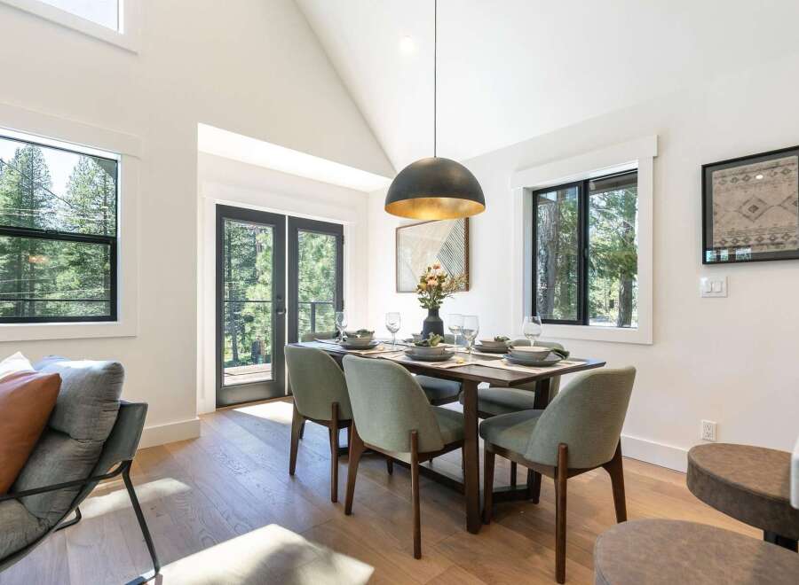 Experience modern mountain living in this stunning dining area, featuring a sleek dining set perfect for intimate gatherings.