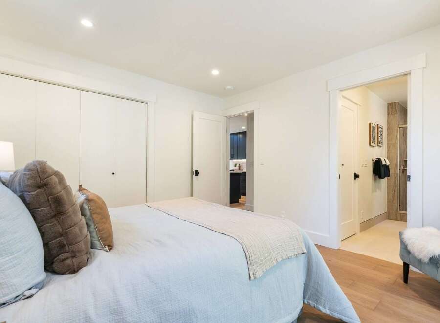 This inviting bedroom features a comfortable bed with plush pillows and a light blue duvet, perfect for relaxation.
