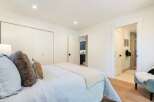 This inviting bedroom features a comfortable bed with plush pillows and a light blue duvet, perfect for relaxation.