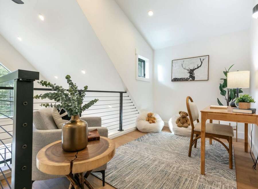 Discover this charming loft space, perfect for a home office or cozy reading nook.