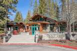 Discover the charming Trout Creek Recreation Center, a beautiful stone and wood building nestled among tall pine trees.