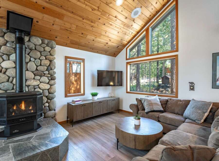 Cozy living room featuring a large stone fireplace with a gas insert, perfect for chilly evenings.