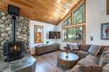 Cozy living room featuring a large stone fireplace with a gas insert, perfect for chilly evenings.