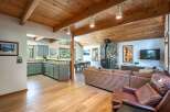 Experience cozy living in this charming mountain retreat, featuring a stunning stone fireplace as the centerpiece of the living area.