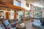 Experience mountain living in this stunning home featuring a spacious open-concept living area with vaulted wood ceilings and a cozy fireplace.