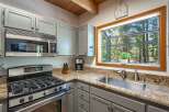 This cozy kitchen features a stainless steel gas range and microwave, perfect for preparing meals.