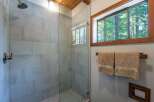 Experience a spa-like retreat in this modern bathroom, featuring a spacious glass-enclosed shower with elegant tilework.