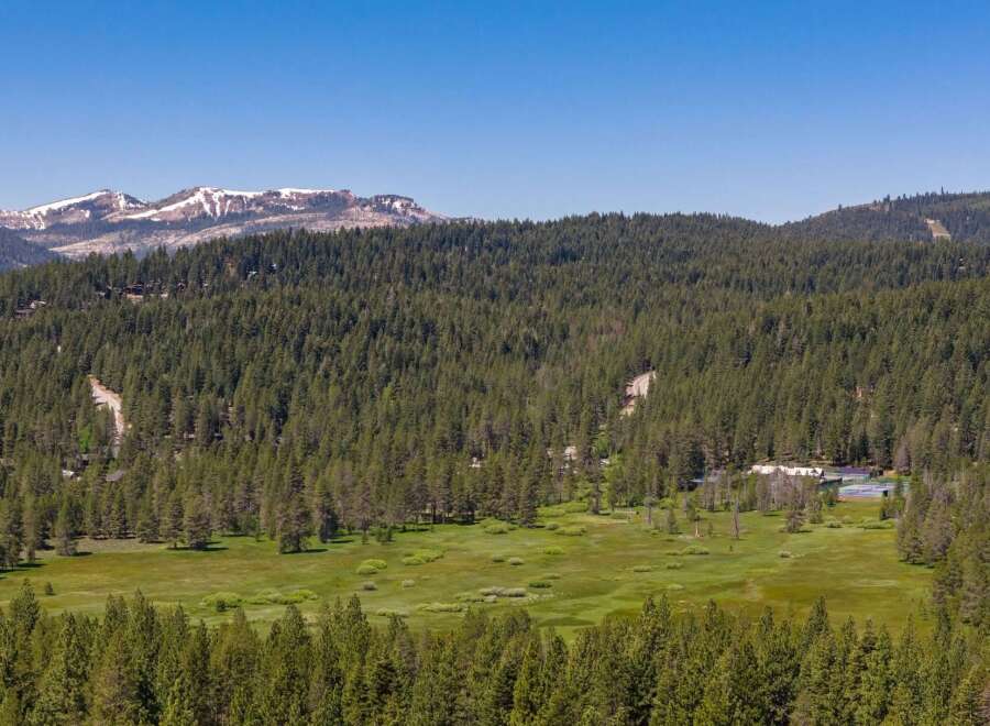 Nestled amidst a vast expanse of evergreen forest, this property offers a serene mountain retreat.