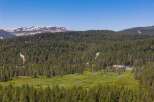 Nestled amidst a vast expanse of evergreen forest, this property offers a serene mountain retreat.