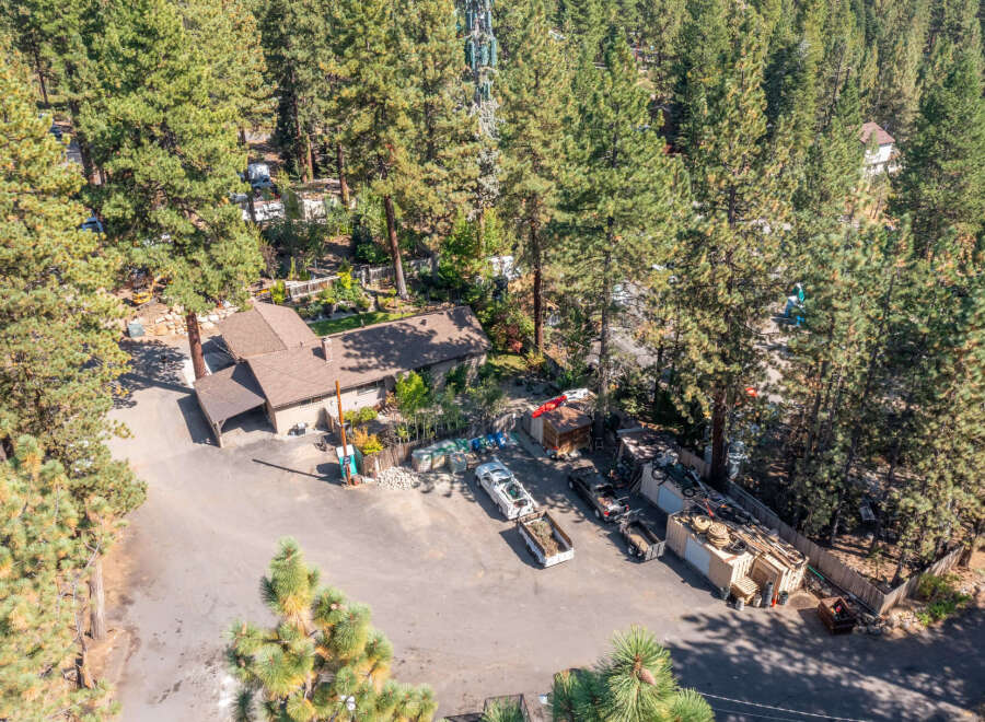Discover this unique property nestled among towering pine trees, offering a serene and private setting.