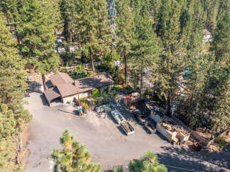 Discover this unique property nestled among towering pine trees, offering a serene and private setting.