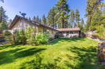 Enjoy the serene backyard of this charming home, complete with a lush green lawn perfect for outdoor activities.