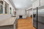 Discover this beautifully renovated kitchen featuring sleek white subway tile backsplash and durable quartz countertops.
