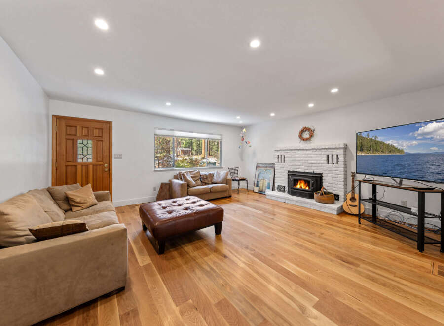 Step into this inviting living room, featuring a cozy fireplace and a large television perfect for entertainment.