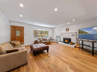 Step into this inviting living room, featuring a cozy fireplace and a large television perfect for entertainment.
