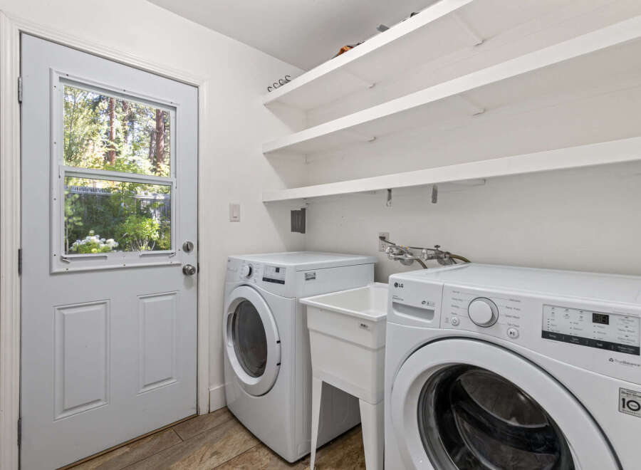 This laundry room features a convenient side-by-side washer and dryer setup, perfect for handling large loads.