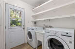 This laundry room features a convenient side-by-side washer and dryer setup, perfect for handling large loads.