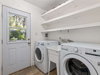 This laundry room features a convenient side-by-side washer and dryer setup, perfect for handling large loads.