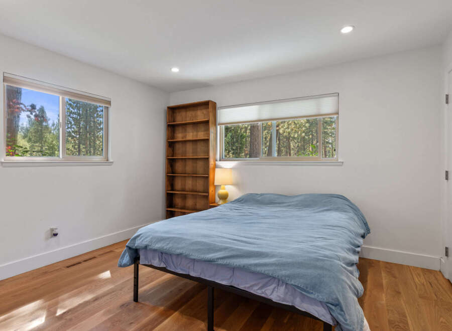 This cozy bedroom features a comfortable bed dressed in a light blue duvet, perfect for relaxation.