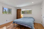 This cozy bedroom features a comfortable bed dressed in a light blue duvet, perfect for relaxation.