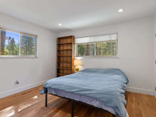 This cozy bedroom features a comfortable bed dressed in a light blue duvet, perfect for relaxation.