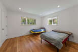 This bright bedroom features two twin beds, perfect for accommodating guests or family.