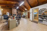 Discover a unique living space with a rustic charm, featuring a soaring wood-beamed ceiling and exposed brick walls.