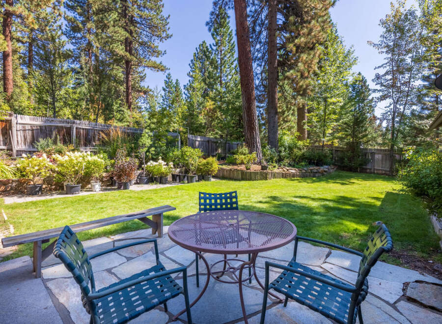Enjoy outdoor living in this charming backyard featuring a spacious patio area perfect for al fresco dining.