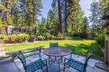 Enjoy outdoor living in this charming backyard featuring a spacious patio area perfect for al fresco dining.