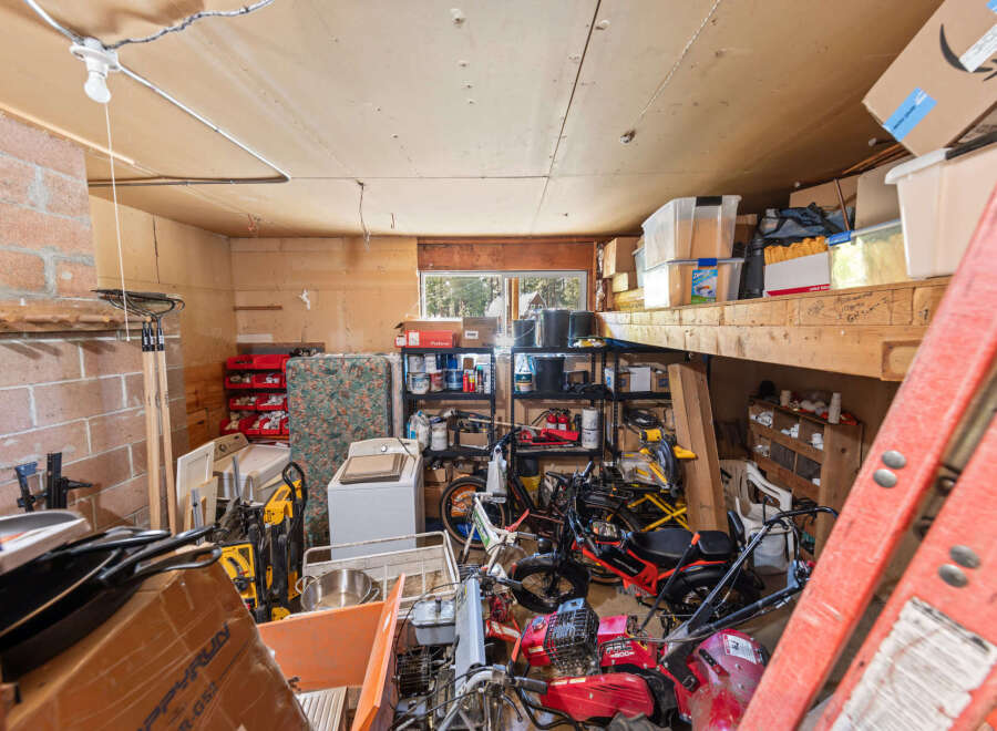 Discover ample storage and workspace in this versatile garage, perfect for your tools and equipment.