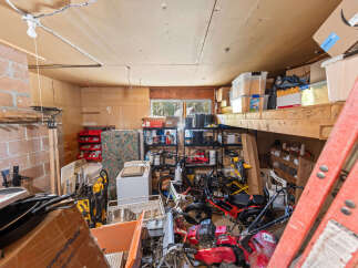 Discover ample storage and workspace in this versatile garage, perfect for your tools and equipment.