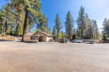 Discover this charming property nestled amongst tall pine trees, offering a serene and private setting.