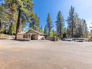 Discover this charming property nestled amongst tall pine trees, offering a serene and private setting.