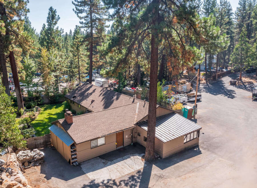 Discover this charming property nestled amongst mature pine trees, offering a serene and private setting.