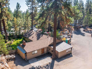 Discover this charming property nestled amongst mature pine trees, offering a serene and private setting.